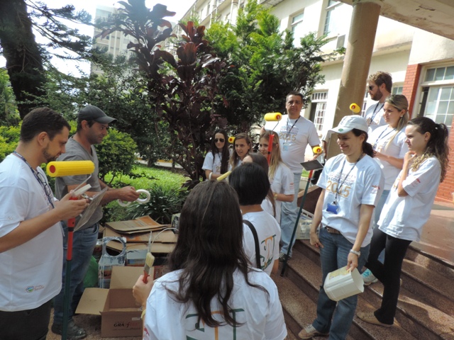 Funcionários da Manutenção ensinam como pintar para os voluntários da Sandoz